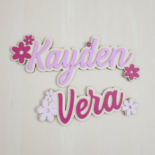 Decorative name pieces with 'Kayden' and 'Vera' on a plain background